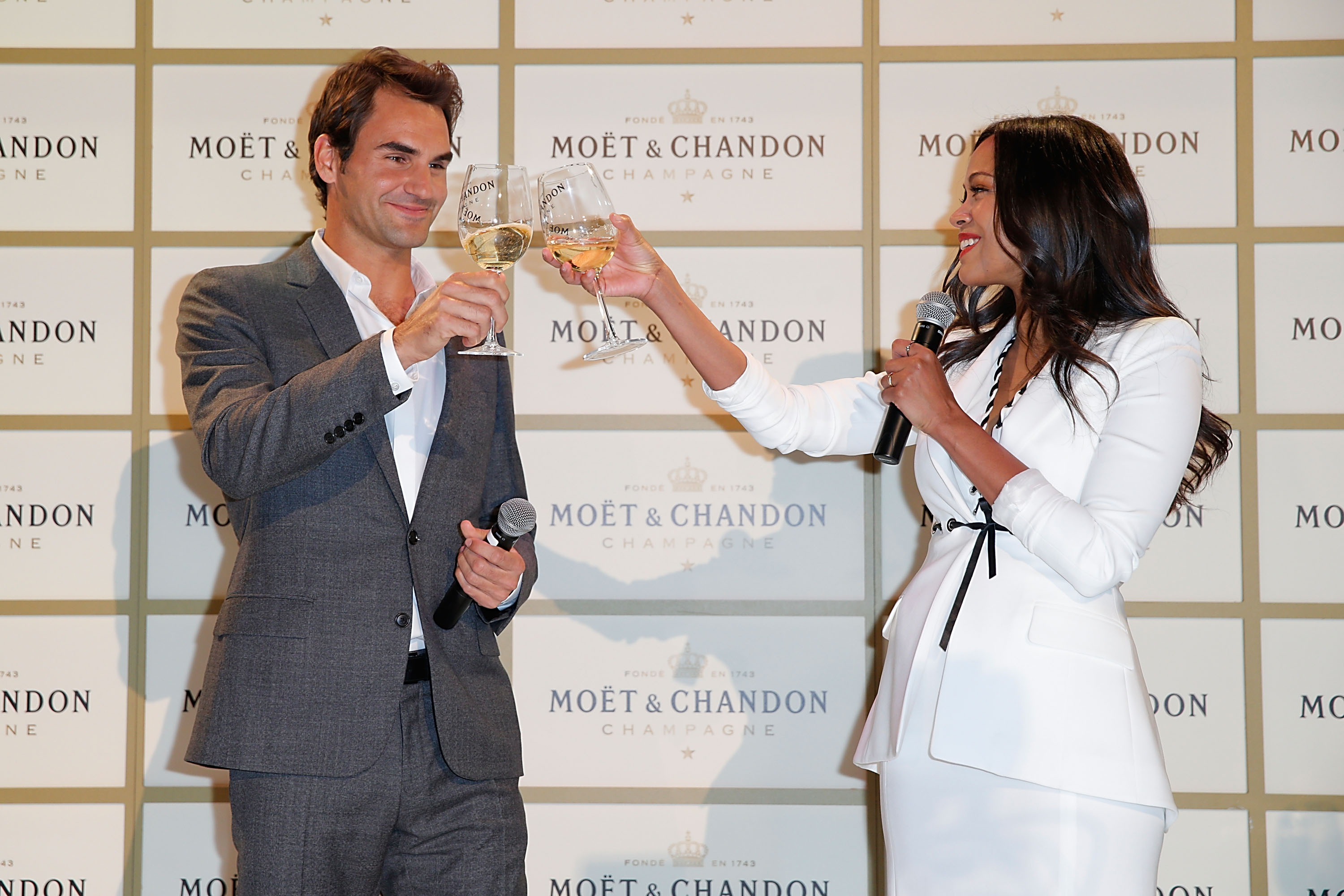 Actress Zoe Saldana (L) and tennis player Roger Federer attend the Moet & Chandon toast to honor brand ambassador Roger Federer's history-making 1,000th career win