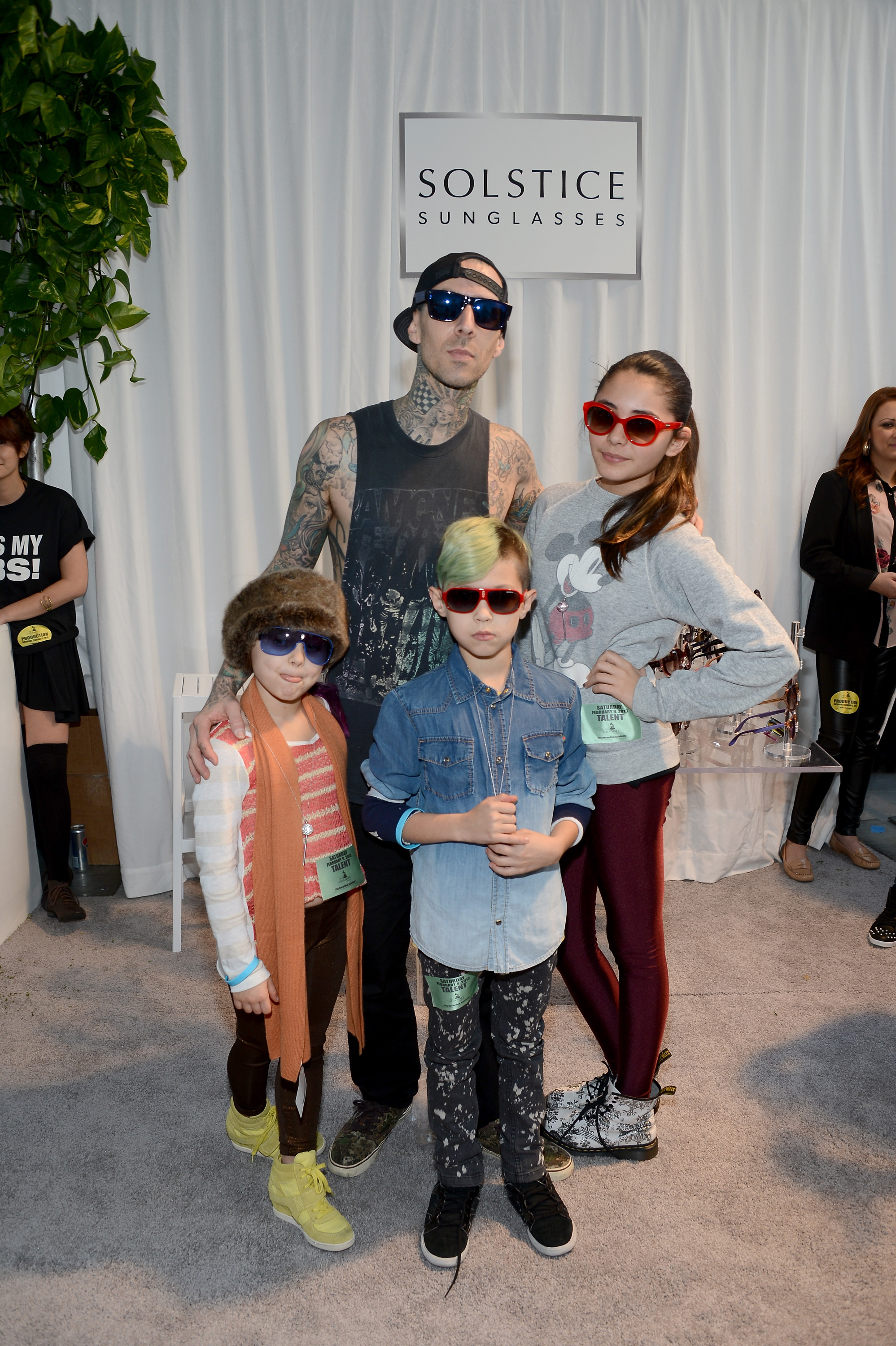 LOS ANGELES, CA - FEBRUARY 09:  Musician Travis Barker in Carrera CA5002S and family pose with SOLSTICE Sunglasses and Safilo USA during the 55th Annual GRAMMY Awards at the STAPLES Center on February 9, 2013 in Los Angeles, California.  (Photo by Amanda Edwards/WireImage)