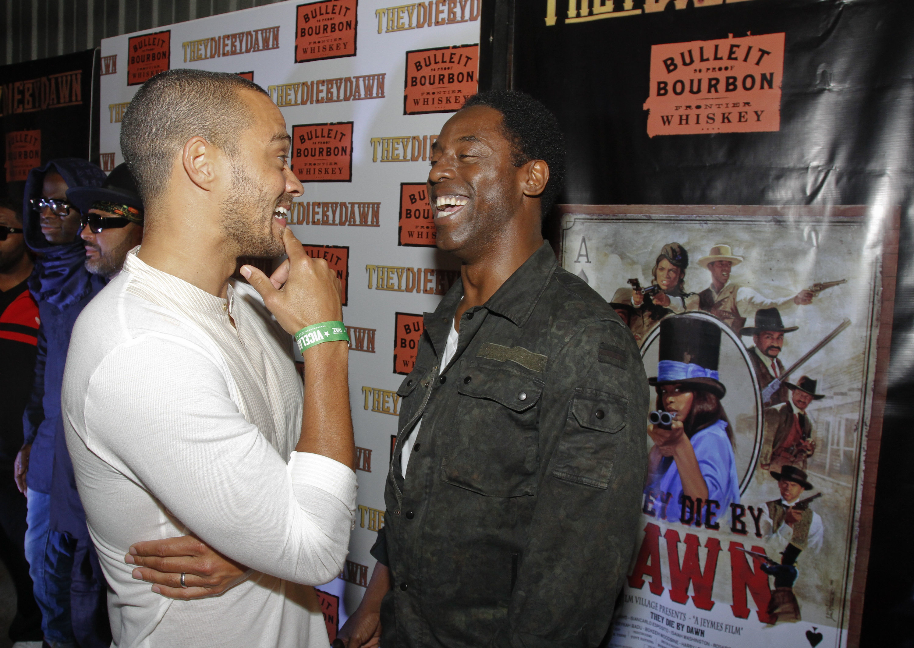 Jesse Williams, left, and Isaiah Washington share a laugh on the red carpet at the Bulleit Bourbon presents "They Die By Dawn" premiere at SXSW on Saturday, March 16, 2013 in Austin, Texas. (Photo by Jack Plunkett/Bulleit Bourbon)