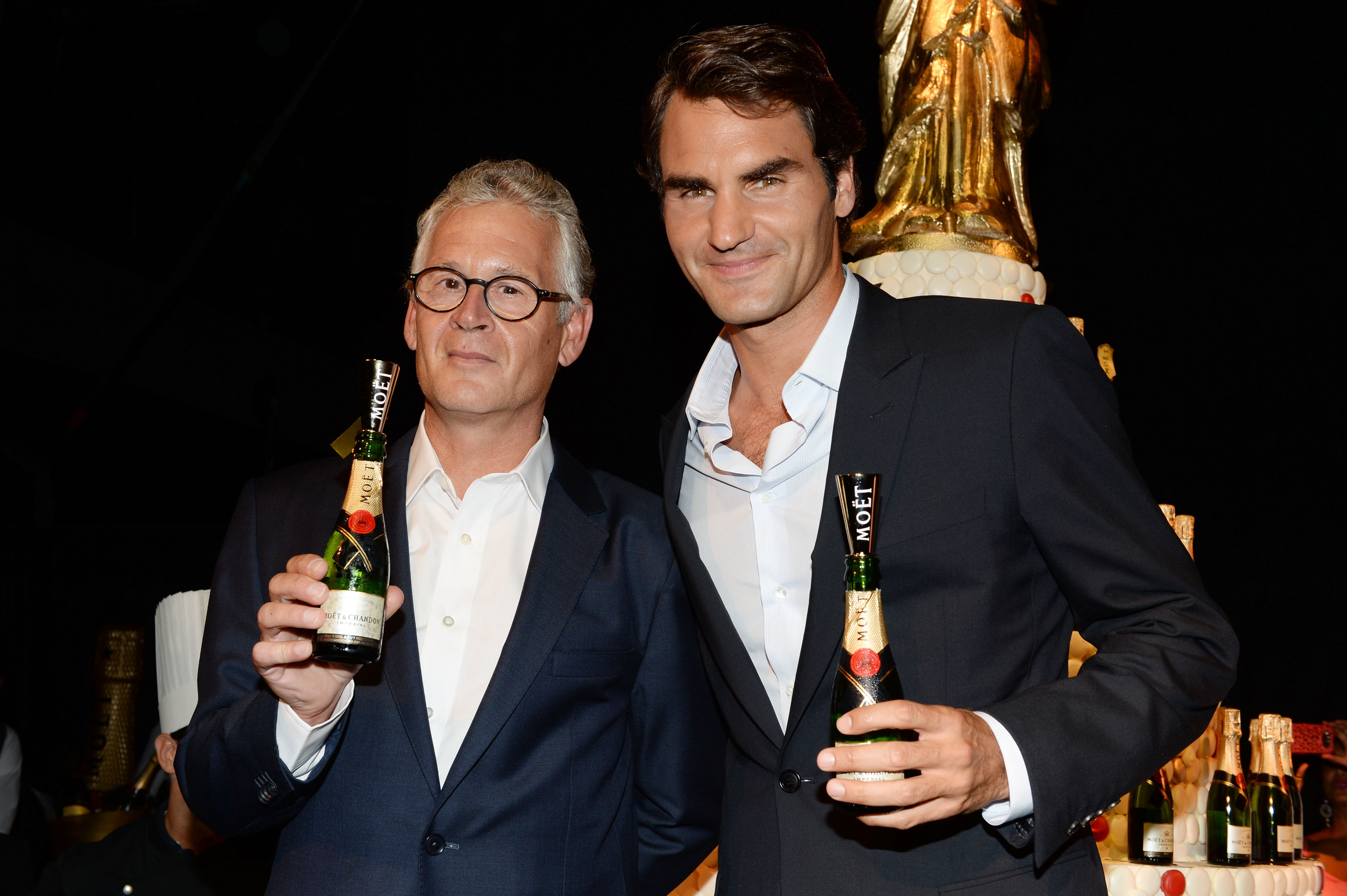 NEW YORK, NY - AUGUST 20:  Moet & Chandon CEO Stephane Baschiera (L) and Professional Tennis Player Roger Federer speak onstage at Moet & Chandon Celebrates Its 270th Anniversary With New Global Brand Ambassador, International Tennis Champion, Roger Federer at Chelsea Piers Sports Center on August 20, 2013 in New York City.  (Photo by Andrew H. Walker/Getty Images for Moet & Chandon)