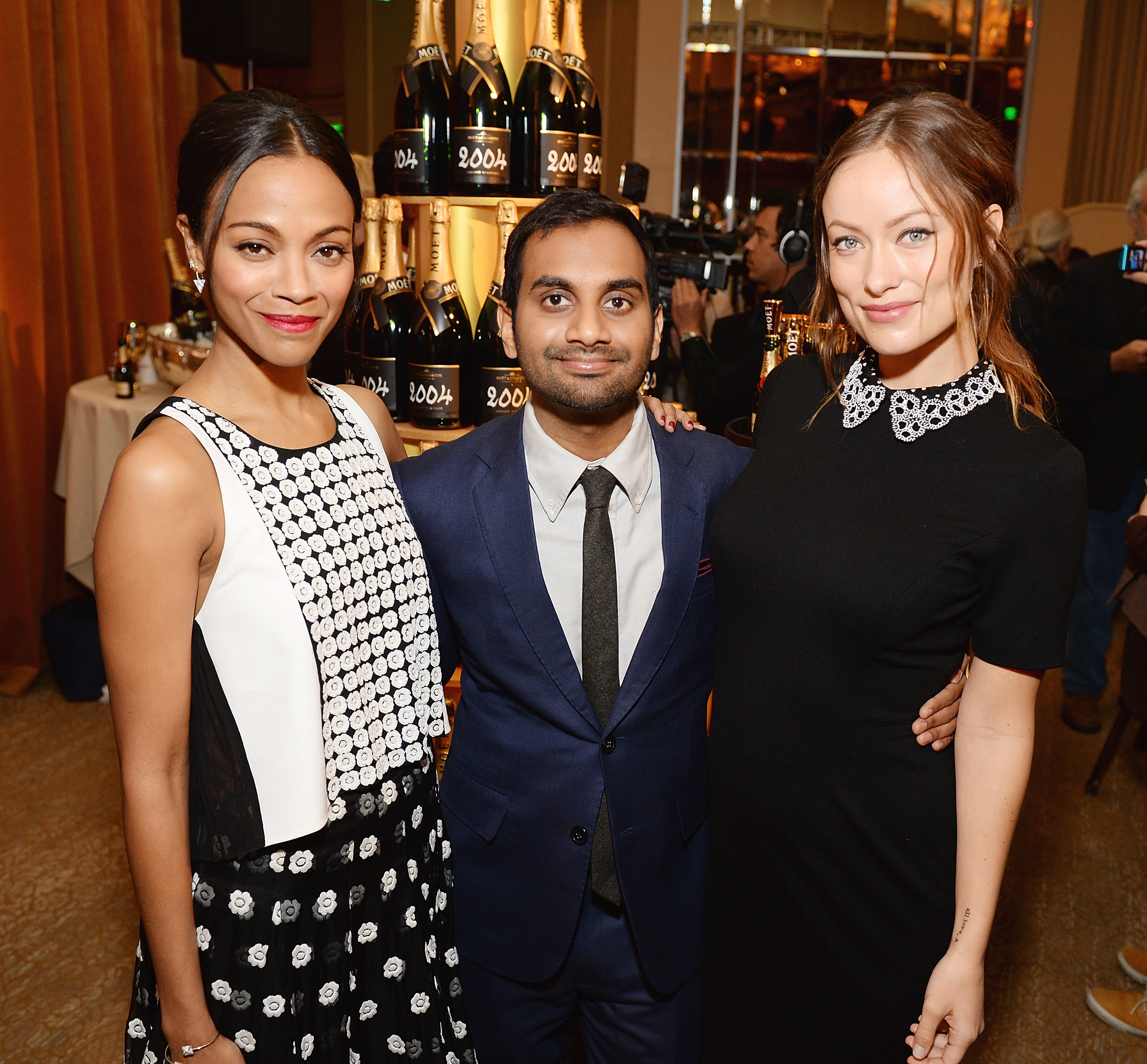 BEVERLY HILLS, CA - DECEMBER 11:  (L-R) Actors Zoe Saldana, Aziz Ansari and Olivia Wilde toast the 71st Annual Golden Globe Nominations with Moet & Chandon at the The Beverly Hilton on December 11, 2013 in Beverly Hills, California.  (Photo by Michael Kovac/WireImage)