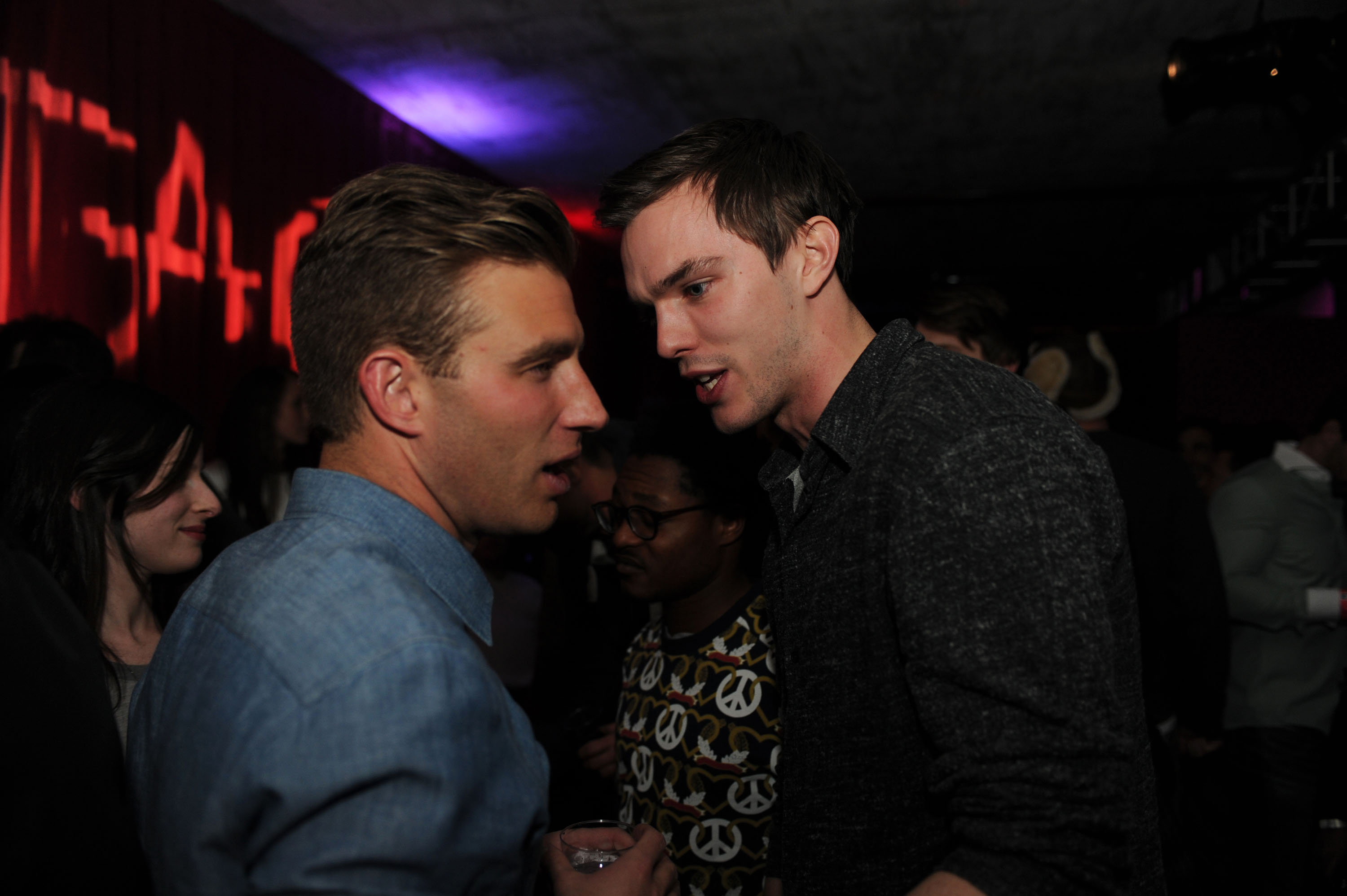 Nicholas Hoult chats with a  friend at TAO at Village at the Lift with Moet & Chandon and Stella Artois