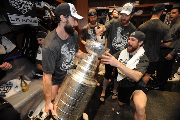 The Los Angeles Kings celebrate in the locker room after defeating the New York Rangers in the second overtime period of Game Five of the 2014 NHL Stanley Cup Final at Staples Center on June 13, 2014 in Los Angeles, California. (Photo by Andrew D. Bernstein/NHLI via Getty Images)
