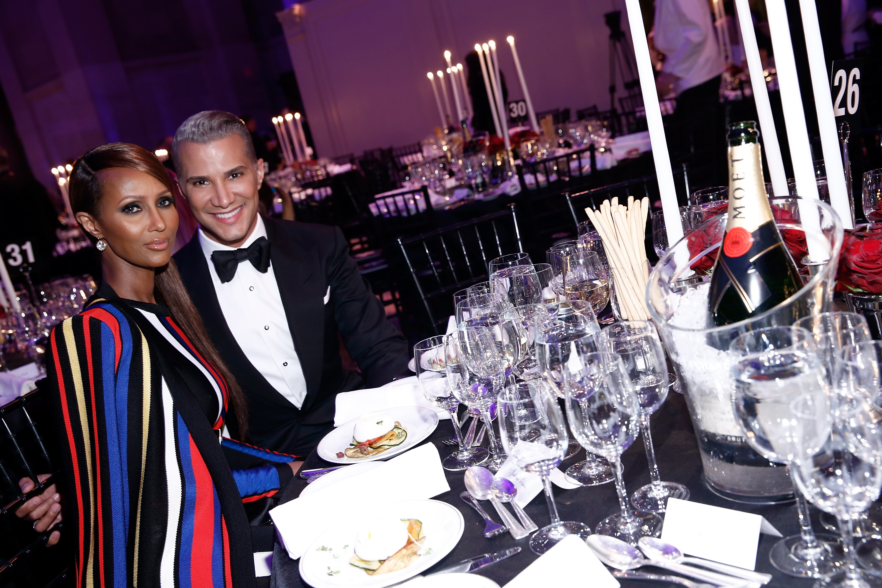 Model Iman Abdulmajid (L) and make up artist Jay Manuel attend the Moet & Chandon toast to the amfAR Gala at Cipriani Wall Street