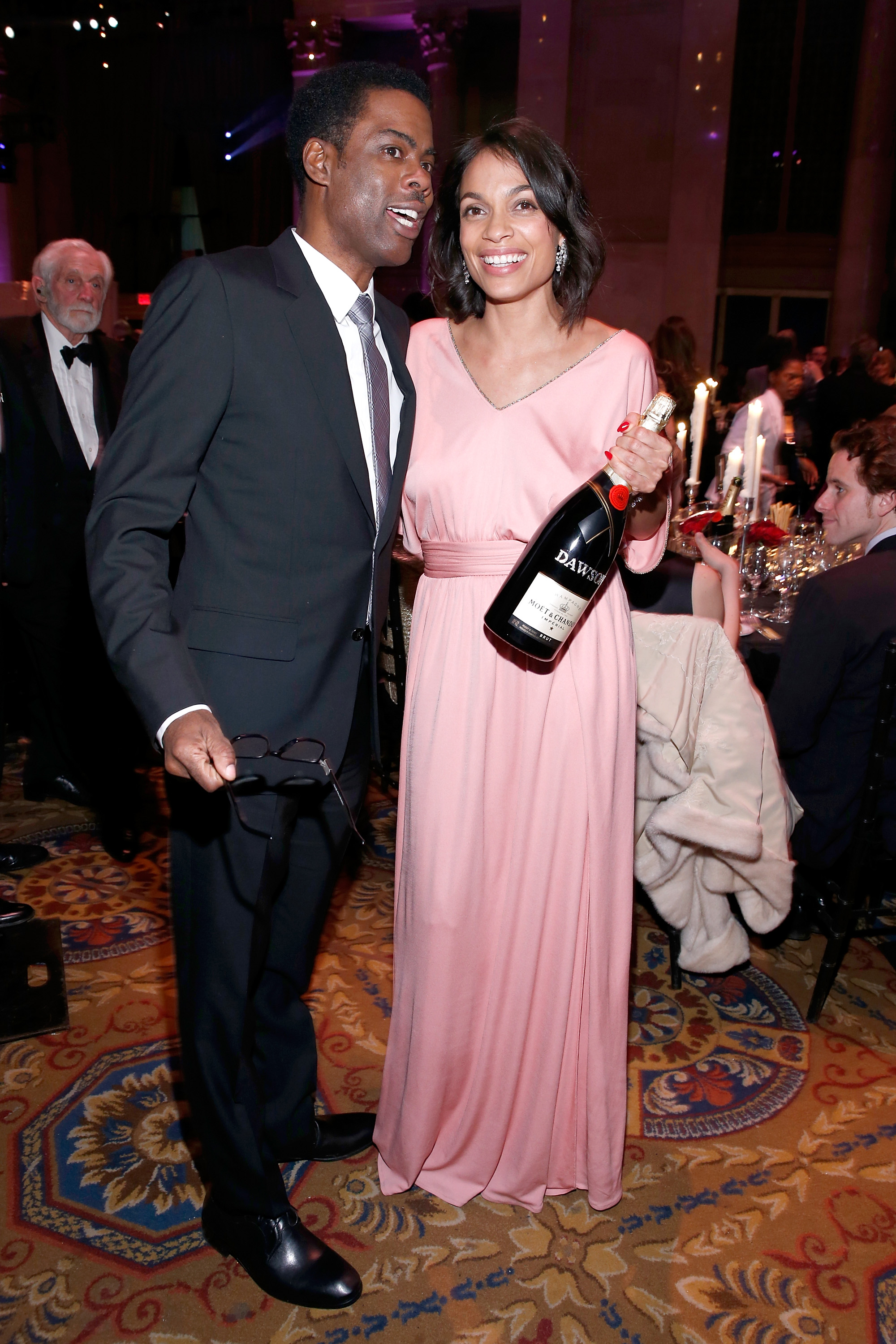 Comedian Chris Rock (L) and actress Rosario Dawson attend the Moet & Chandon toast to the amfAR Gala at Cipriani Wall Street