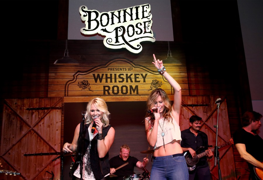 NASHVILLE, TN - JULY 13:  Kristen Kuiper and Skye Claire of Whiskey Rose perform onstage during the product launch of Bonnie Rose, a new Tennessee white whiskey, on July 13, 2015 in Nashville, Tennessee.  (Photo by Terry Wyatt/Getty Images for Bonnie Rose)