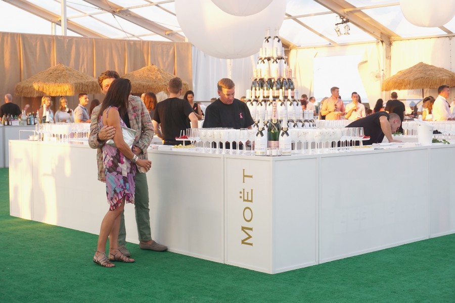 BRIDGEHAMPTON, NY - AUGUST 01:  Guests toasts to Paddle for Pink with Moet Ice Imperial on August 1, 2015 in Bridgehampton, New York.  (Photo by Steven Henry/Getty Images for Moet & Chandon)