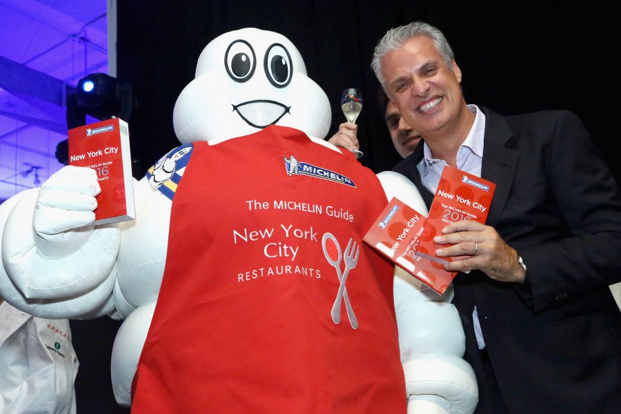 NEW YORK, NY - SEPTEMBER 30: Chef Eric Ripert poses with the 'Michelin Man' during the Michelin celebration of the 2016 Michelin Star Chef and restaurant recipients from New York City at Classic Car Club on September 30, 2015 in New York City. (Photo by Astrid Stawiarz/Getty Images for Michelin)